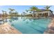 Resort-style pool with a clubhouse, lounge chairs, and palm trees at 1530 Moon Valley Dr, Davenport, FL 33896