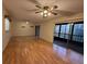 Spacious living room with wood-look flooring, ceiling fans, and sliding glass doors to a balcony at 190 Hickory Woods Ct # 12B, Deltona, FL 32725