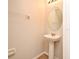 Clean bathroom with pedestal sink and circular mirror at 1939 Chatham Place Dr, Orlando, FL 32824