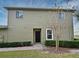 Exterior view of a two-story home with a black door and landscaped bushes at 1939 Chatham Place Dr, Orlando, FL 32824