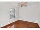 Empty bedroom with hardwood floors, white walls, and a ceiling fan at 234 N Glenwood Ave # 4, Orlando, FL 32803
