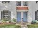 Close-up of two light blue front doors of a townhouse, framed by white walls and black shutters at 234 N Glenwood Ave # 4, Orlando, FL 32803