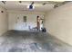 Two-car garage with concrete floor, water heater, and electrical panel at 234 N Glenwood Ave # 4, Orlando, FL 32803