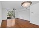 Bright living room with gleaming hardwood floors, white walls, and large sliding glass doors at 234 N Glenwood Ave # 4, Orlando, FL 32803