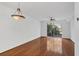 Spacious living room with hardwood floors, white walls, a ceiling fan, and sliding glass doors to a balcony at 234 N Glenwood Ave # 4, Orlando, FL 32803