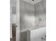 Modern bathroom showcasing gray tiled shower walls and white accents at 3931 Avenue R Nw, Winter Haven, FL 33881