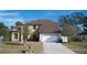 Two-story house with a two-car garage and landscaped yard at 4915 Labrador Ln, Orlando, FL 32818