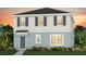 Charming two-story home with a welcoming front porch and landscaped yard at 5040 Oak Seed Way, St Cloud, FL 34771