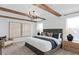 Spacious primary bedroom with exposed beams and elegant décor at 5040 Oak Seed Way, St Cloud, FL 34771