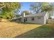 Home's back exterior with windows, chimney, and fenced yard at 5416 Higgins Way, Orlando, FL 32808