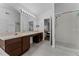 Main bathroom with double vanity, walk-in shower, and tile flooring at 6019 Bay Valley Ct, Orlando, FL 32819