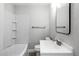 Clean bathroom boasts white tile, a modern vanity, and updated fixtures at 625 N 3Rd St, Lake Alfred, FL 33850