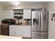 Clean and modern kitchen with white cabinetry and stainless steel appliances at 6510 Corona Dr, Orlando, FL 32810
