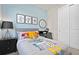 bedroom with light blue walls, robot bedding, and black furniture at 6944 Rosy Sky Ave, Orlando, FL 32829