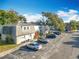 An aerial view showcasing a condo building with surrounding trees and parking at 7309 Daniel Webster Dr # O-3A, Winter Park, FL 32792