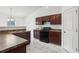 Stylish kitchen boasting dark wood cabinets, a double sink, and modern appliances at 1004 Puget Ln, Kissimmee, FL 34759