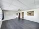 Living room with dark gray vinyl flooring and built-in shelving at 1013 Carlson Dr, Orlando, FL 32804