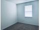 Empty bedroom with gray carpet, white walls, and window with blinds at 15271 Willow Arbor Cir, Orlando, FL 32824