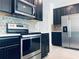 Kitchen with stainless steel appliances, dark cabinets, and white countertops at 15271 Willow Arbor Cir, Orlando, FL 32824