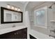 Updated bathroom with a marble-topped vanity and geometric tile at 1550 Indiana Ave, Winter Park, FL 32789