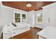 Cozy bedroom with hardwood floors and wood paneled ceiling at 1550 Indiana Ave, Winter Park, FL 32789