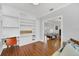 Home office with built-in shelving and hardwood floors at 1550 Indiana Ave, Winter Park, FL 32789