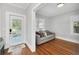 Bright sunroom features hardwood floors, comfy couch, and access to the backyard at 1550 Indiana Ave, Winter Park, FL 32789