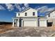 New two-story home with a two-car garage and a paved driveway at 2075 Heart Lake Dr, Groveland, FL 34736