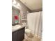 Clean bathroom with dark vanity, shower, and decorative accents at 2464 Deer Creek Blvd, St Cloud, FL 34772