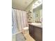Clean bathroom with shower/tub combo, dark vanity, and decorative shelving at 2464 Deer Creek Blvd, St Cloud, FL 34772