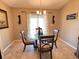 Bright dining area with glass table and four chairs, near sliding doors at 2464 Deer Creek Blvd, St Cloud, FL 34772