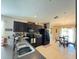 Modern kitchen with dark cabinets, stainless steel appliances, and breakfast nook at 2464 Deer Creek Blvd, St Cloud, FL 34772