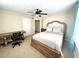 Bright bedroom with a large bed, desk and ceiling fan at 2904 S Peninsula Dr, Daytona Beach Shores, FL 32118