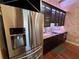 Modern kitchen featuring stainless steel appliances, dark cabinets, and granite countertops at 2904 S Peninsula Dr, Daytona Beach Shores, FL 32118