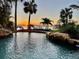 Stunning pool at sunset with palm trees surrounding at 2904 S Peninsula Dr, Daytona Beach Shores, FL 32118
