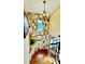 Open staircase with stone wall and chandelier at 2904 S Peninsula Dr, Daytona Beach Shores, FL 32118