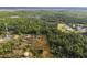 Aerial perspective of rural property with outbuildings nestled among trees at 3520 Hyder Ave, Deltona, FL 32738