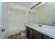 Clean bathroom with white tile, dark vanity, and gold fixtures at 3749 Fox Hollow Dr, Orlando, FL 32829