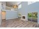 Living room with vaulted ceiling, fireplace, wood-look flooring, and sliding patio doors at 3749 Fox Hollow Dr, Orlando, FL 32829