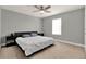 A bedroom featuring a king-size bed, soft carpeting, and a ceiling fan at 4937 Blanche Ct, Saint Cloud, FL 34772