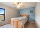 Cozy bedroom with a ceiling fan and blue accent wall at 5761 Woodruff Way, Lakeland, FL 33812