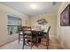 Dining room with arched window, wooden table, and carpeted floors at 5761 Woodruff Way, Lakeland, FL 33812