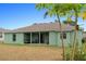 Exterior view of the home's backyard, showcasing a covered patio area at 5761 Woodruff Way, Lakeland, FL 33812