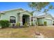 One-story home with a green exterior, landscaped yard, and decorative statues at 5761 Woodruff Way, Lakeland, FL 33812