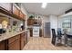 Kitchen featuring granite countertops, wooden cabinetry, and stainless steel appliances at 5761 Woodruff Way, Lakeland, FL 33812