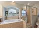 Inviting Primary bathroom featuring a soaking tub, separate shower, and dual vanities at 5761 Woodruff Way, Lakeland, FL 33812