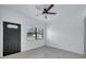 Living room with hardwood floors, large window, and neutral color scheme at 6015 Walbridge St, Orlando, FL 32809