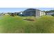Expansive backyard with a screened-in patio and view of the community lake at 6535 Shimmering Shores Ln, St Cloud, FL 34771
