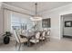 Elegant dining room with stylish chandelier, large windows, and views of the water at 6535 Shimmering Shores Ln, St Cloud, FL 34771