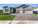 Beautiful single-Gathering home with a welcoming front porch, large driveway, and a two-car garage at 6535 Shimmering Shores Ln, St Cloud, FL 34771